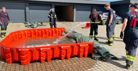 Pouring water into the EasyWall Barrier during the flood training